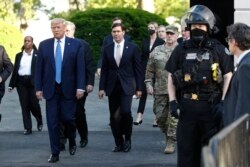 FILE - President Donald Trump departs the White House to walk to St. John's Church in Washington, June 1, 2020. Defense Secretary Mark Esper is to Trump's right.