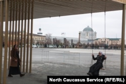 A woman swings in the Chechen capitol of Grozny on January 29, 2019.