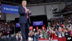 President Donald Trump walks toward his podium to begin speaking at a campaign rally at Kansas Expocentre, Oct. 6, 2018, in Topeka, Kan.