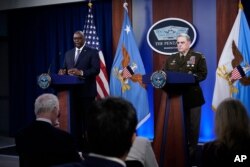 Secretary of Defense Lloyd Austin, left, answers a question during a briefing with Joint Chiefs Chairman Gen. Mark Milley at the Pentagon in Washington, Sept. 1, 2021, about the end of the war in Afghanistan.