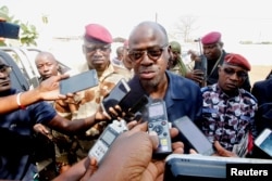 FILE - Ivory Coast's Minister of Defence Alain-Richard Donwahi speaks to the media as he arrives to speak with mutinous soldiers in Bouake, Ivory Coast, Jan. 7, 2017.