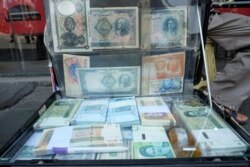 FILE - A man displays the Iranian currency at Ferdowsi square in Tehran, Iran, July 2, 2020. (Mohamadreza Nadimi/WANA (West Asia News Agency) via Reuters)