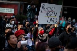 FILE - People take part in a Stop Asian Hate rally at Times Square in New York City, April 4, 2021.