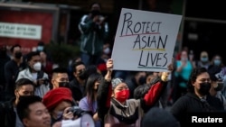 FILE - People take part in a Stop Asian Hate rally at Times Square in New York City, April 4, 2021.