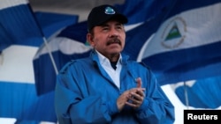 FILE - Nicaraguan President Daniel Ortega applauds during a march in Managua, Sept. 5, 2018. 