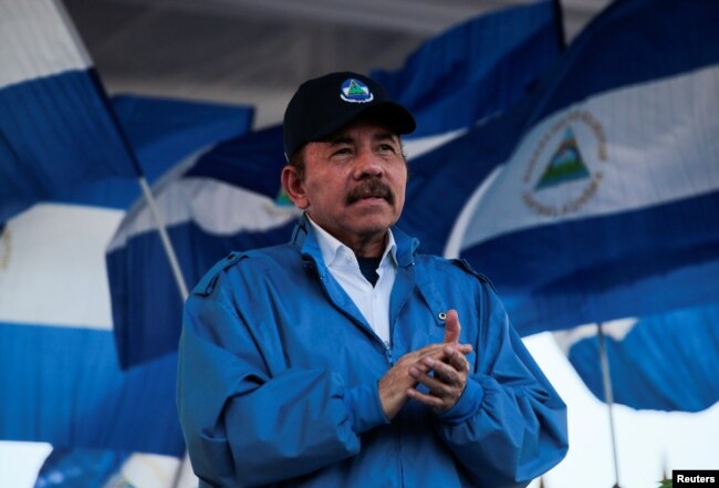 FILE - Nicaraguan President Daniel Ortega applauds during a march in Managua, Sept. 5, 2018.