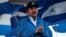 FILE - Nicaraguan President Daniel Ortega applauds during a march in Managua, Sept. 5, 2018. 