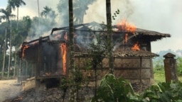 FILE - Houses are on fire in Gawdu Zara village, northern Rakhine state, Myanmar, Sept. 7, 2017.