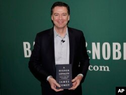 Former FBI director James Comey poses for photographs at a Barnes & Noble book store before speaking, in New York, April 18, 2018.