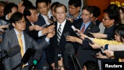 U.S. Special Representative for North Korea Policy Glyn Davies (C) answers reporters' questions after his talks with South Korean chief delegate to the six-party talks on North Korea's denuclearization Lim Sung-nam (not pictured), at the foreign ministry