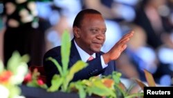 FILE - Kenya's President Uhuru Kenyatta reacts as he attends Mashujaa (Heroes) Day at the Nyayo National Stadium in Nairobi, Oct. 20, 2013. 