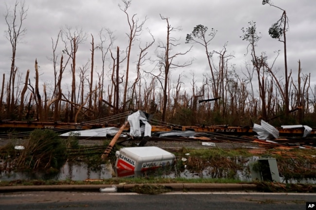 Shredded trees, derailed train cars and a sunken trailer are seen in the aftermath of Hurricane Michael in Panama City, Fla., Oct. 10, 2018.