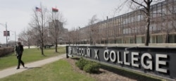 A student walks across campus at Malcolm X College, Thursday, April 1, 2010, in Chicago. (AP Photo/M. Spencer Green)