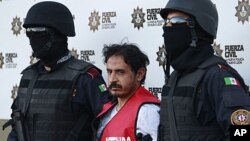 Baltazar Saucedo Estrada (C) is presented to the media at police headquarters in Monterrey, January 6, 2012.