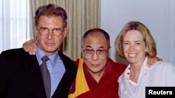 FILE - From left, actor Harrison Ford, the Dalai Lama of Tibet and Harrison's then-wife, Melissa Mathison, pose at a fundraiser for Tibet at the Regent Beverly Wilshire Hotel in Los Angeles, Aug. 1, 1996. Mathison died Nov. 4, 2015, at the age of 65.