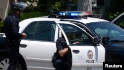 LAPD surround a house where a man armed with a rifle barricaded himself, in Los Angeles, California June 9, 2014. The man, who led police on a chase from East Los Angeles to North Hollywood, was wanted for making threats and has been taken into custody af