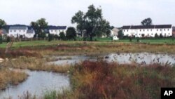 Lititz Run prior to restoration with eroded stream banks and few shade trees, an unwelcome habitat for trout