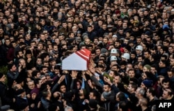 FILE - People carry the coffin of Yunus Gormek, 23, one of the victims of the Reina nightclub attack, during his funeral ceremony, Jan. 2, 2017 in Istanbul.