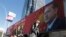 People walk past a huge billboard with an image of Turkey's President Recep Tayyip Erdogan that reads "Yes" in Turkish, in Ankara, Turkey, March 22, 2017. A referendum set for April 16 could boost Erdogan's powers.