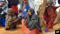 FILE - A mother of 12 (center), who was displaced from her village due to drought, sits among a group of women in the town of Werder, in Ethiopia's Somali region, June 9, 2017.