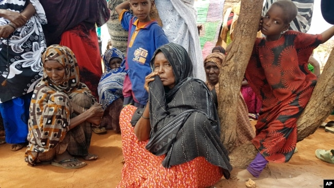 Ader Ali Yusuf, center, a mother of 12 who was displaced from her village due to the drought in Ethiopia, sits among a group of women as an international delegation visits the Warder town of Ethiopia's drought stricken area, June 9, 2017.