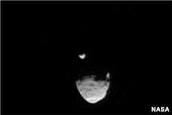 A screenshot shows Martian moon Phobos passing in front of smaller moon, Deimos.