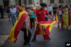 Men perform a mock bullfighting game after a mass rally against Catalonia's declaration of independence, in Barcelona, Spain, Oct. 29, 2017.