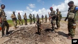 FILE - Somali soldiers stand at a Somali military base, near the site of an attack by al-Shabab, in Lower Juba, June 13, 2018. The base was the target of another al-Shabab assault Monday.