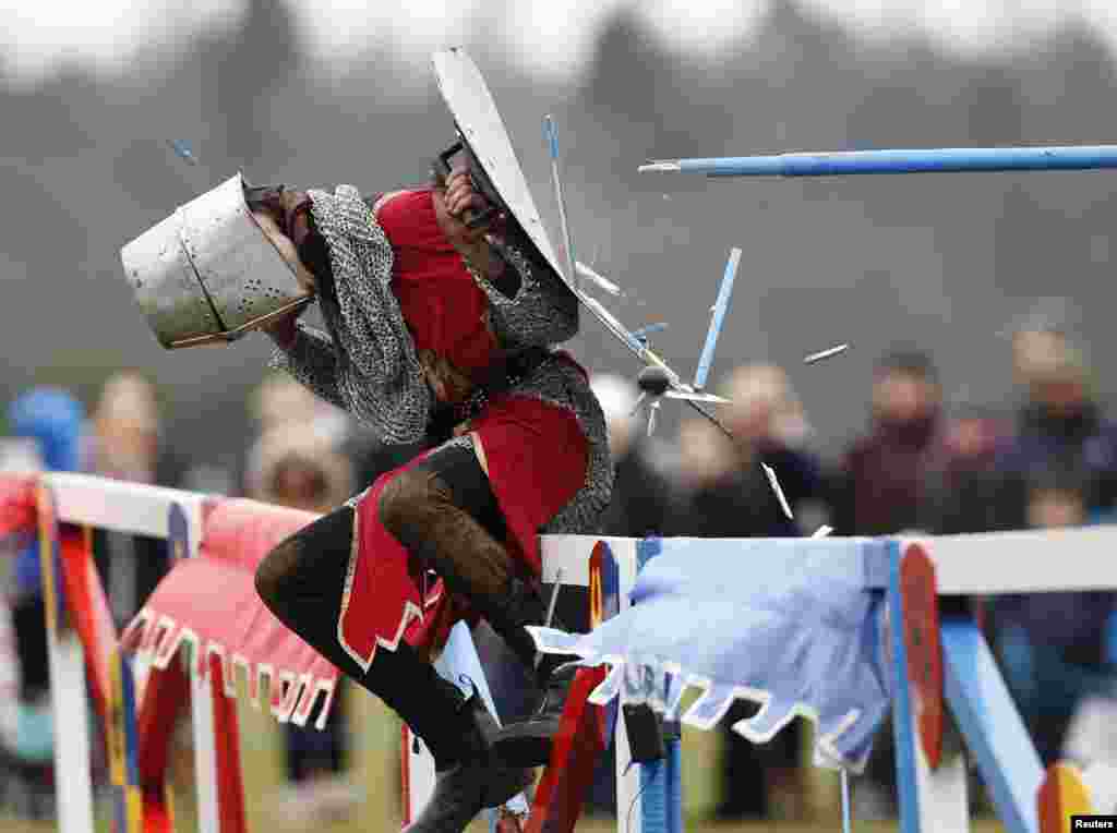A performer dressed as a squire holds a shield as he is hit with a lance at Knebworth House in Hertfordshire, Britain, Apr. 1, 2013. Knebworth House, a stately home of the Lytton family since 1490, hosted The Knights Of Royal England in their first medieval jousting tournament of the season.