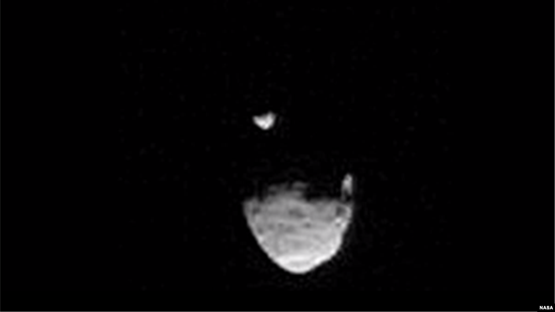 A screenshot shows Martian moon Phobos passing in front of smaller moon, Deimos.