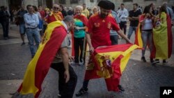 Men perform a mock bullfighting game after a mass rally against Catalonia's declaration of independence, in Barcelona, Spain, Oct. 29, 2017. 