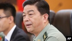 FILE - In this July 18, 2013 file photo Chinese Defense Minister Chang Wanquan speaks during a meeting at Chinese Defense Ministry headquarters in Beijing. 