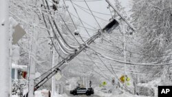 A police vehicle blocks a road near downed power lines, March 8, 2018, in Natick, Massachusetts.