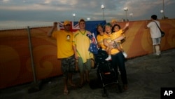 FILE - Australian tourists pose for a snapshot outside the National Stadium, also known as the "Bird's Nest," in Beijing, China.