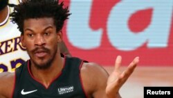 Oct 4, 2020; Orlando, Florida, USA; Miami Heat forward Jimmy Butler (22) passes the ball against the Los Angeles Lakers during the third quarter of game three of the 2020 NBA Finals at AdventHealth Arena. Mandatory Credit: Kim Klement-USA TODAY Sports