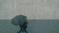 A pedestrian walks with an umbrella outside of the Chase Center in San Francisco, Dec. 22, 2021.