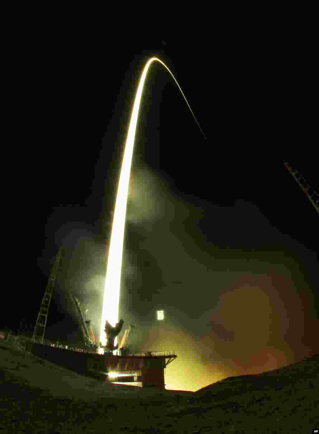 The Soyuz-FG rocket booster with Soyuz TMA-08M space ship blasts off at the Russian leased Baikonur cosmodrome, Kazakhstan. The Russian rocket carries Russian Cosmonauts Alexander Misurkin and Pavel Vinogradov and U.S. astronaut Christopher Cassidy to to the International Space Station.