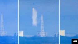 Screen grabs from Japanese national broadcaster NHK show a Japanese military cargo helicopter dumping water onto reactor number 3 at the stricken Fukushima nuclear power plant on March 17, 2011