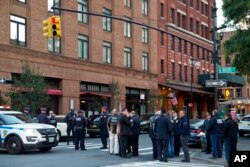 Police stand watch near a building associated with Robert De Niro after reports of a suspicious package, in New York, Oct. 25, 2018.