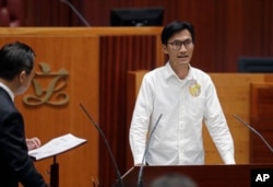 Newly elected pro-democracy lawmaker Eddie Chu takes oath in the new legislature Council in Hong Kong, Wednesday, Oct. 12, 2016.