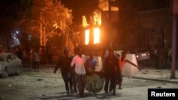 Rescue workers evacuate an injured man from the scene where a suicide car bomb exploded targeting a Mogadishu hotel in a business center at Maka Al Mukaram street in Mogadishu, Somalia. Feb. 28, 2019. 