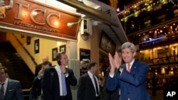U.S. Secretary of State John Kerry returns a warm greeting from a crowd as he leaves the Foreign Correspondents Club Restaurant in Phnom Penh, Cambodia, Monday, Jan. 25, 2016. (AP Photo/Jacquelyn Martin, Pool)