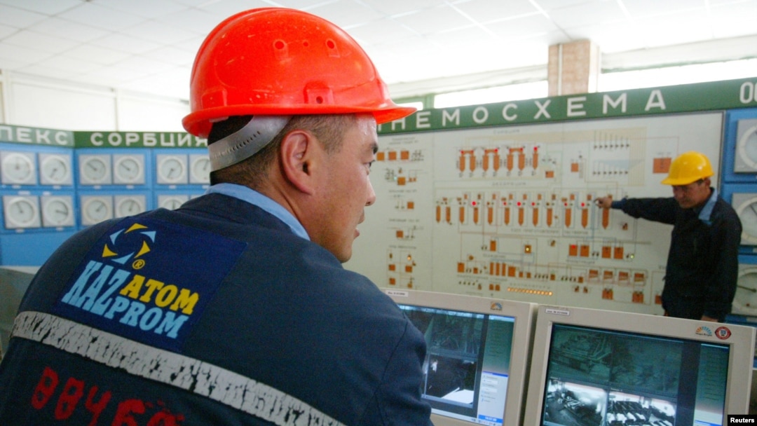 FILE - Kazatomprom staff work in the control room of the East Mynkuduk PV-19 uranium mine in southern Kazakhstan, May 11, 2006.