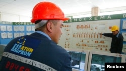 FILE - Kazatomprom staff work in the control room of the East Mynkuduk PV-19 uranium mine in southern Kazakhstan, May 11, 2006.