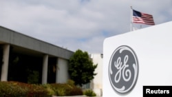FILE - The logo of Dow Jones Industrial Average stock market index listed company General Electric is shown at their subsidiary company GE Aviation in Santa Ana, California, Apr. 13, 2016. 