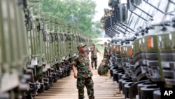 FILE PHOTO - A Cambodian army soldier looks at Chinese military vehicles displayed before a handover ceremony at a military airbase in Phnom Penh, Cambodia.