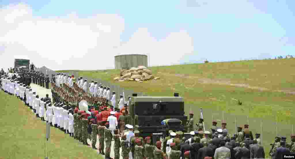 The coffin of South African former president Nelson Mandela is escorted by the military to the funeral ceremony in Qunu, South Africa, Dec. 15, 2013.&nbsp;