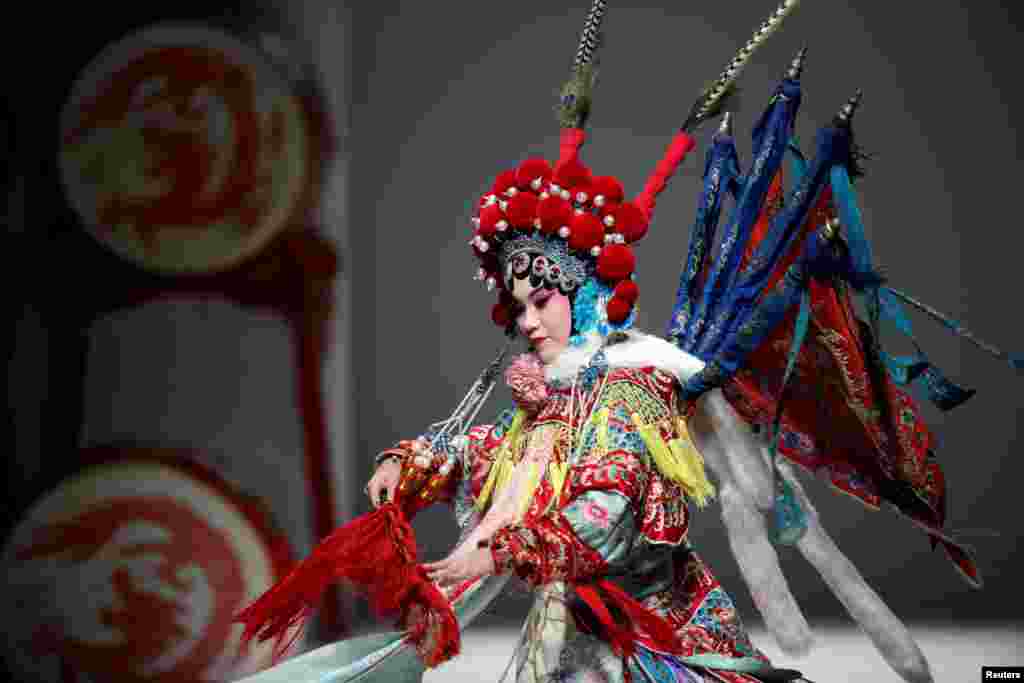 A Beijing Opera performer dances during a show by designer Hao Weimin at China Fashion Week, China.