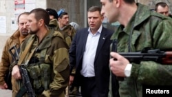 FILE - Head of the self-proclaimed Donetsk people's republic Alexander Zakharchenko (C) is seen surrounded by bodyguards in Donetsk, eastern Ukraine.