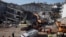 Emergency personnel work at the site of damaged buildings after an earthquake in Elazig, Turkey, Jan. 27, 2020. 